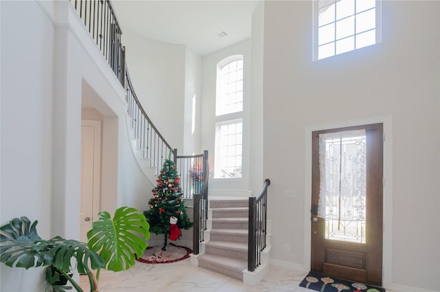 foyer with plenty of natural light and a high ceiling