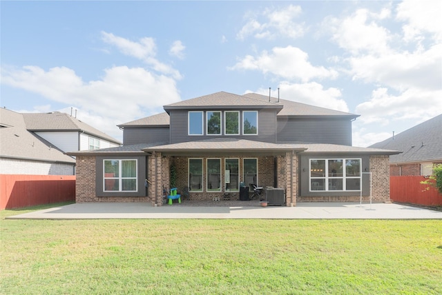 rear view of property featuring a patio area, a yard, and cooling unit