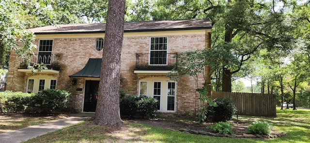 view of front of house featuring a balcony