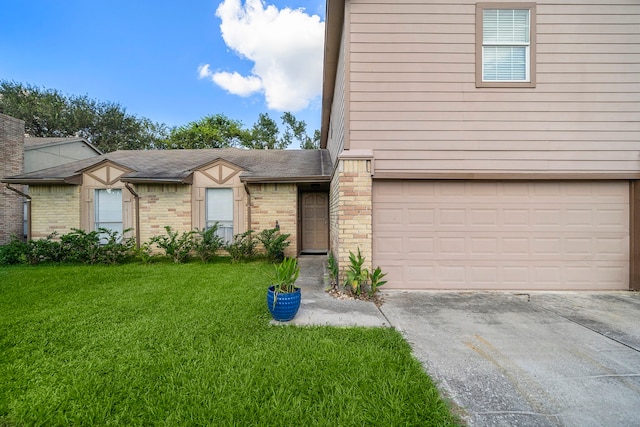 view of front of house featuring a garage and a front lawn