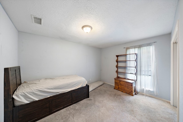 carpeted bedroom with a textured ceiling