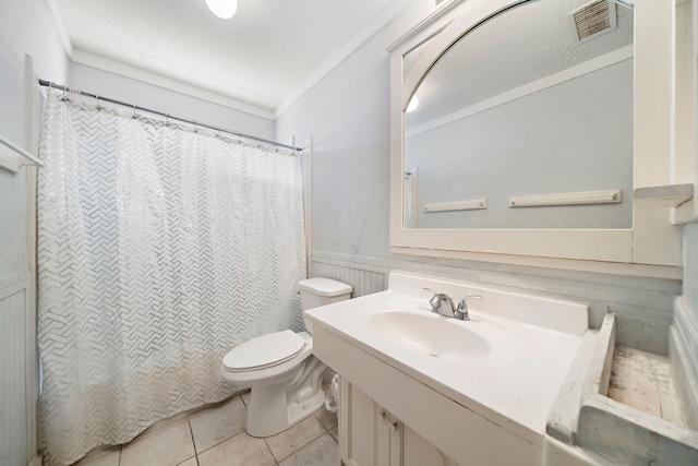 bathroom with tile patterned floors, a textured ceiling, toilet, vanity, and ornamental molding