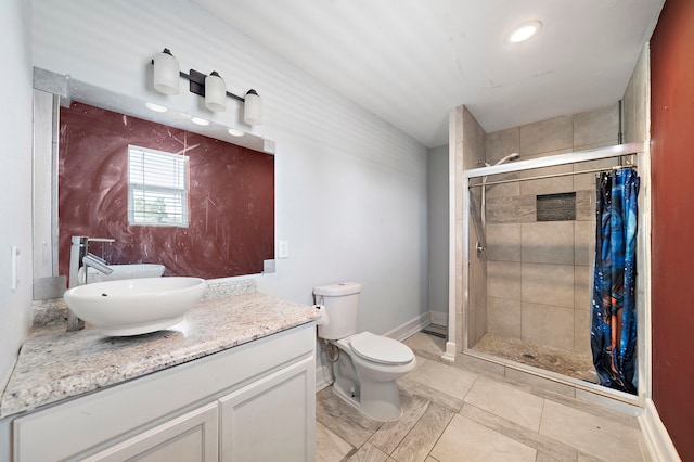 bathroom with toilet, a tile shower, lofted ceiling, and vanity