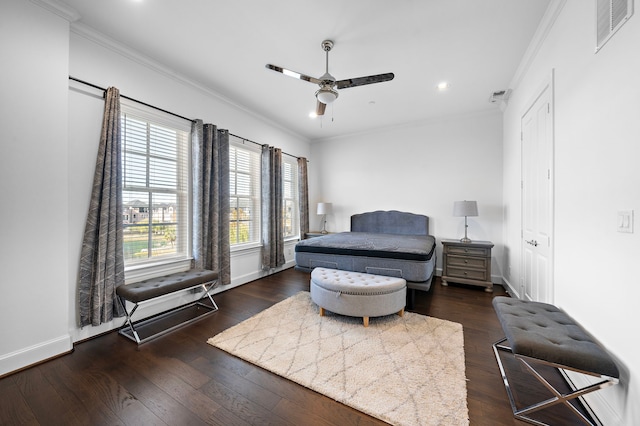 bedroom with dark hardwood / wood-style floors, ceiling fan, and crown molding