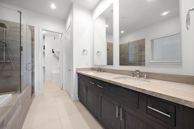 bathroom with tile patterned floors, vanity, and walk in shower