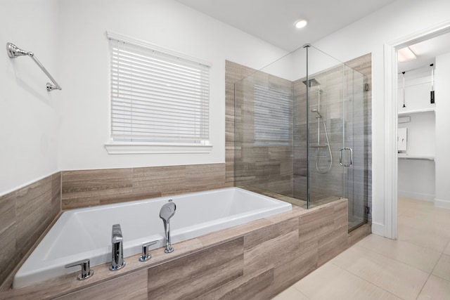 bathroom with tile patterned floors and shower with separate bathtub