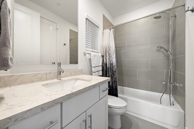 full bathroom featuring tile patterned flooring, vanity, toilet, and shower / bathtub combination with curtain