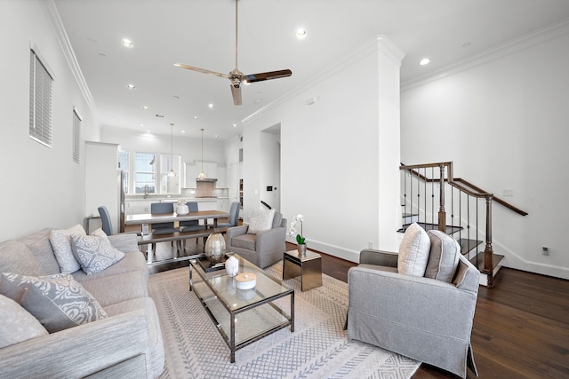 living room with crown molding, ceiling fan, and wood-type flooring