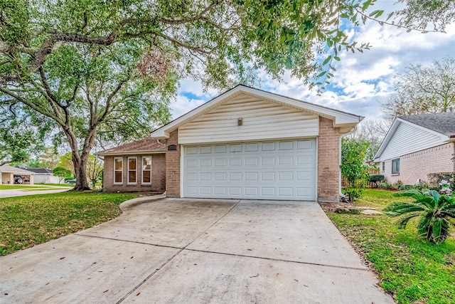 view of front of property featuring a front lawn, brick siding, driveway, and an attached garage