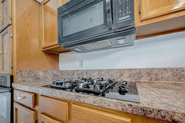 kitchen featuring tile countertops and black appliances