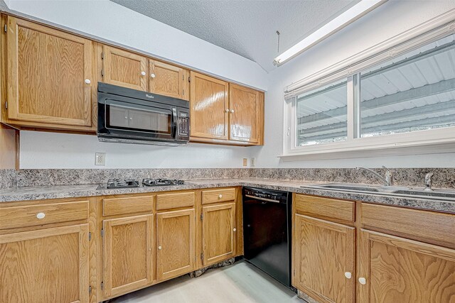 kitchen with a textured ceiling, black appliances, a sink, and lofted ceiling