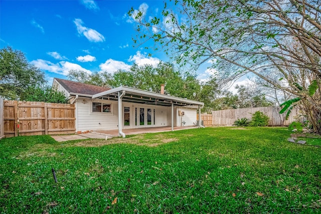 back of house with french doors, a patio area, a lawn, and a fenced backyard