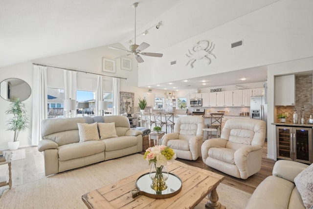 living room featuring ceiling fan, beverage cooler, light hardwood / wood-style floors, and high vaulted ceiling