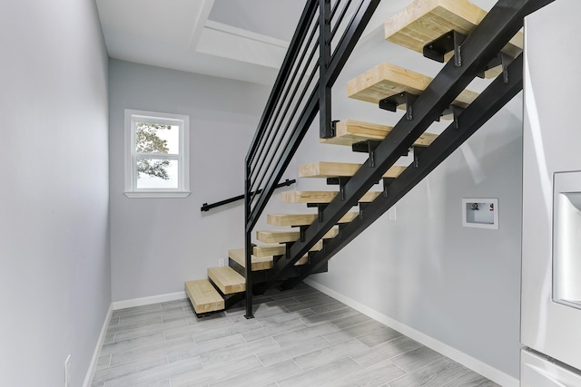 stairway featuring wood-type flooring