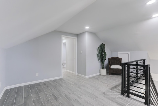 bonus room featuring vaulted ceiling and light hardwood / wood-style flooring