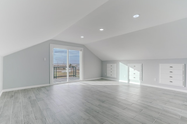 bonus room with built in features, light hardwood / wood-style flooring, and vaulted ceiling