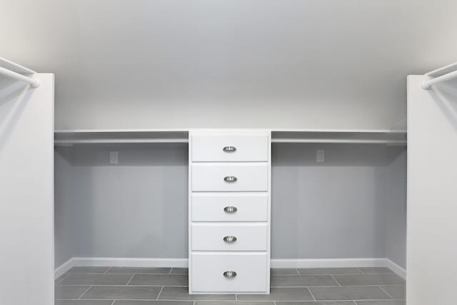 spacious closet with dark tile patterned flooring