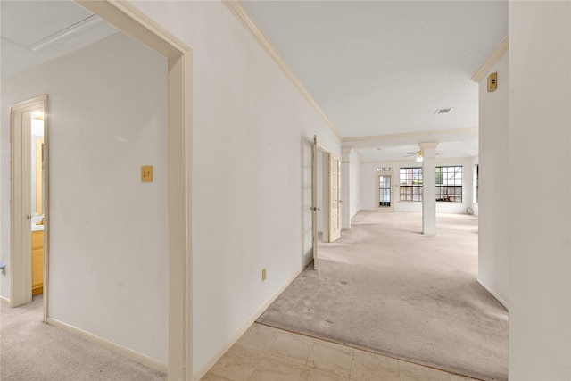 hall featuring light carpet and ornamental molding