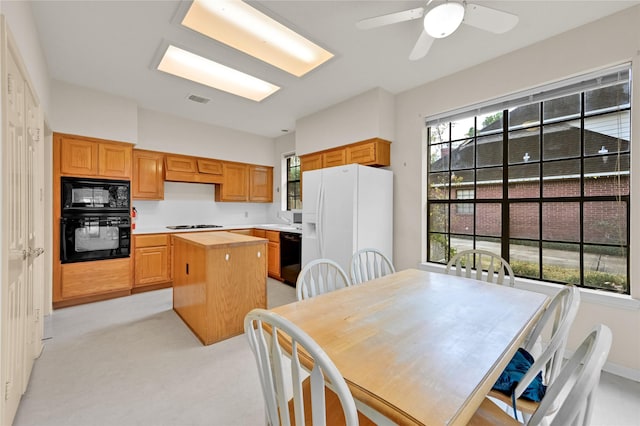 7810 Timberline Run Ln, Houston, TX 77095 - kitchen featuring black appliances, a center island, light colored carpet, butcher block counters, and a ceiling fan