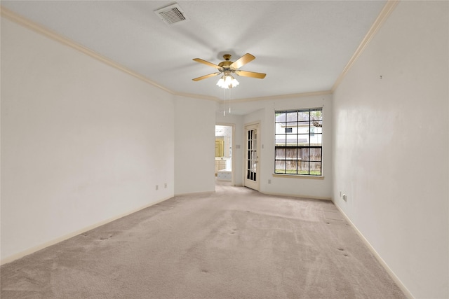 carpeted empty room featuring ceiling fan and ornamental molding