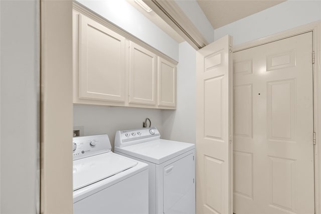 laundry area with cabinets and washing machine and dryer