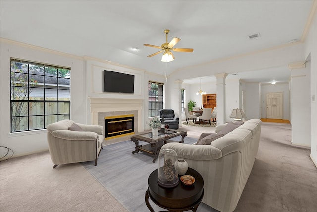 living room with ceiling fan with notable chandelier, light colored carpet, and a fireplace