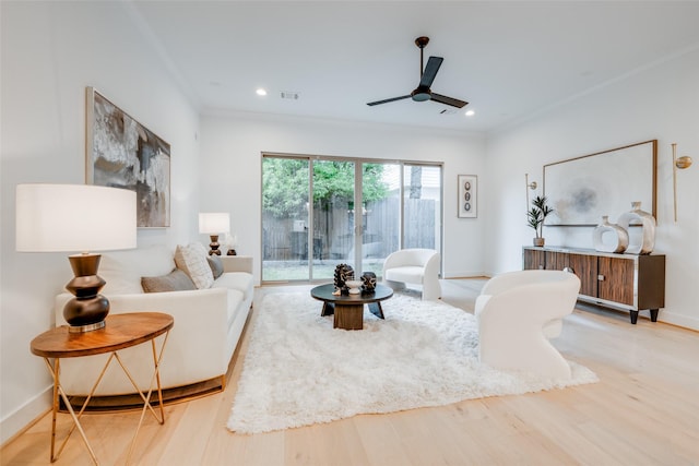 living room with ceiling fan and light hardwood / wood-style flooring