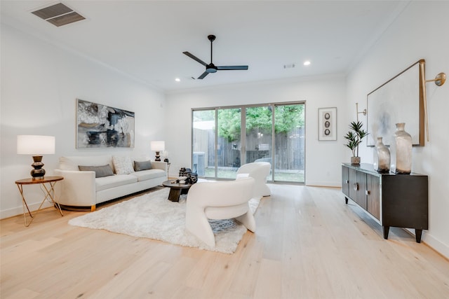 living room with ceiling fan, light hardwood / wood-style floors, and crown molding