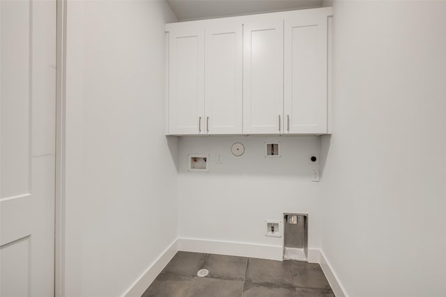 clothes washing area featuring cabinets, electric dryer hookup, hookup for a gas dryer, and hookup for a washing machine