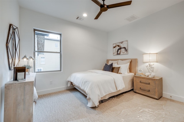 bedroom with ceiling fan and light carpet