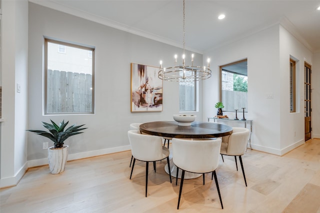 dining space featuring light wood-type flooring, crown molding, and a notable chandelier