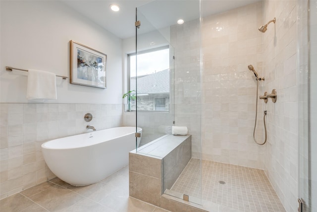 bathroom featuring separate shower and tub, tile patterned floors, and tile walls