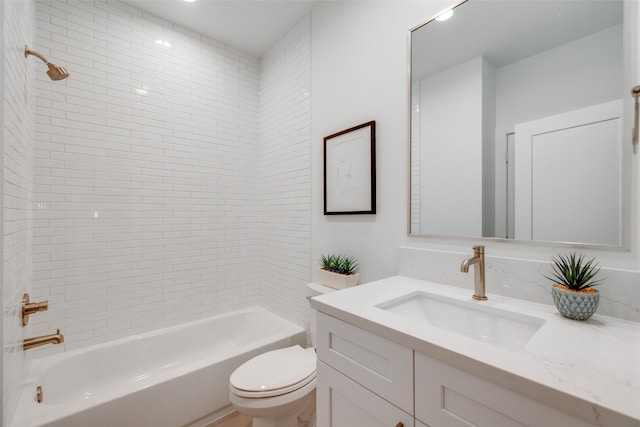 full bathroom featuring vanity, toilet, and tiled shower / bath