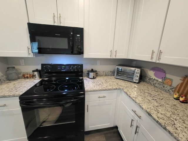 kitchen with white cabinetry and black appliances