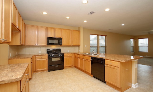 kitchen with light brown cabinetry, sink, plenty of natural light, and black appliances