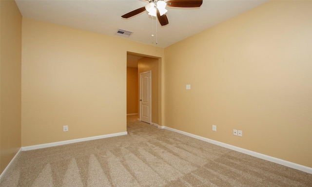 empty room featuring light colored carpet and ceiling fan