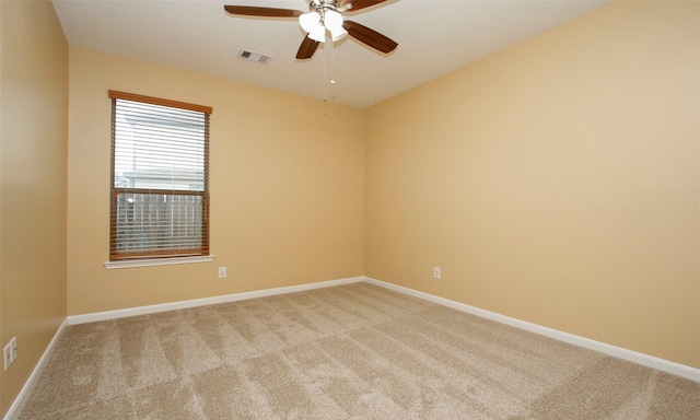 spare room featuring ceiling fan and light colored carpet