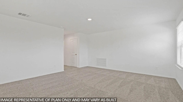 spare room with light colored carpet