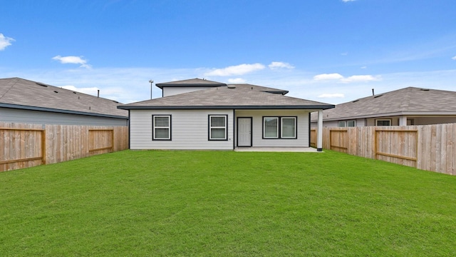 back of property featuring a patio area and a yard