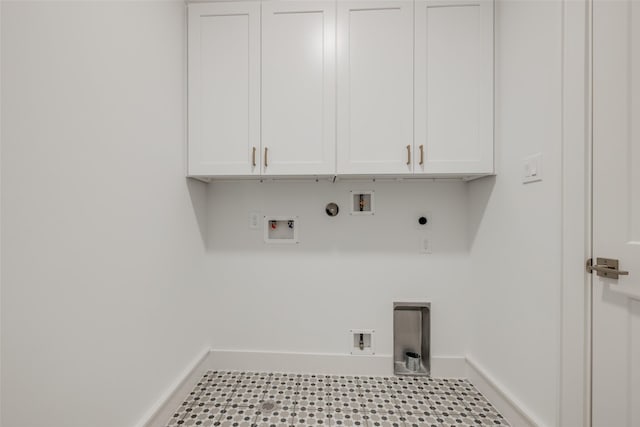 laundry room featuring baseboards, hookup for an electric dryer, cabinet space, washer hookup, and hookup for a gas dryer