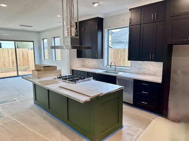 kitchen with recessed lighting, a sink, appliances with stainless steel finishes, crown molding, and tasteful backsplash