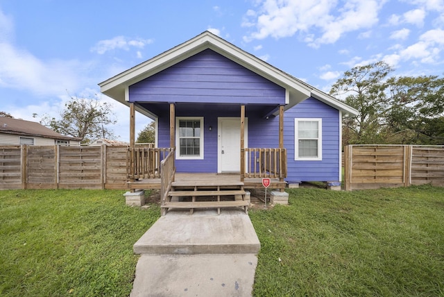 bungalow-style home featuring a porch and a front yard