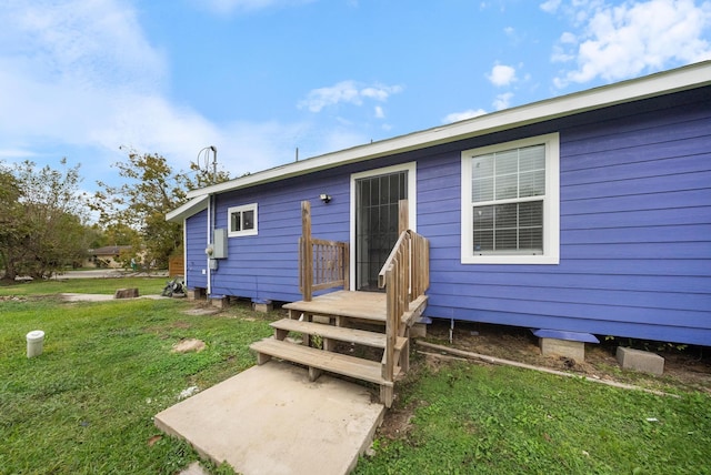 rear view of house with a yard