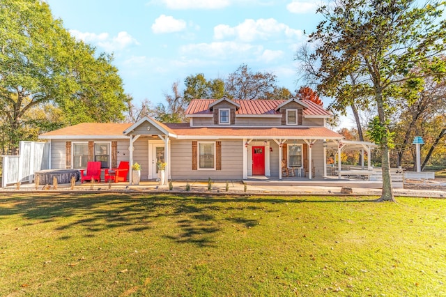 view of front of property featuring metal roof, a front lawn, and a standing seam roof