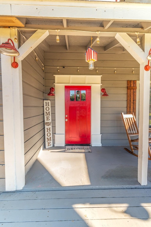 view of exterior entry with a porch