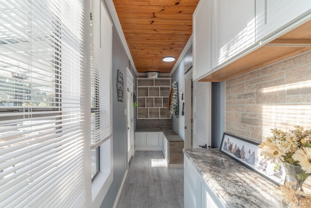 hallway featuring wooden ceiling and wood finished floors