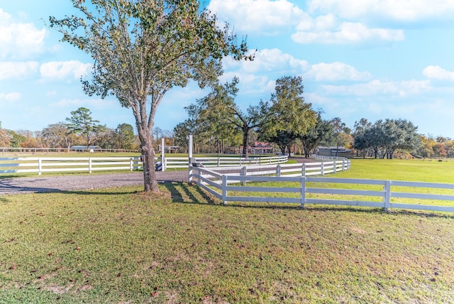 view of yard featuring a rural view and fence