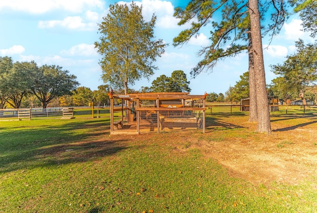 exterior space with fence, a lawn, and an outbuilding