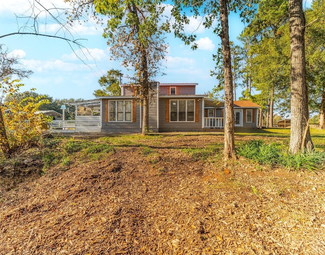 rear view of property with a yard