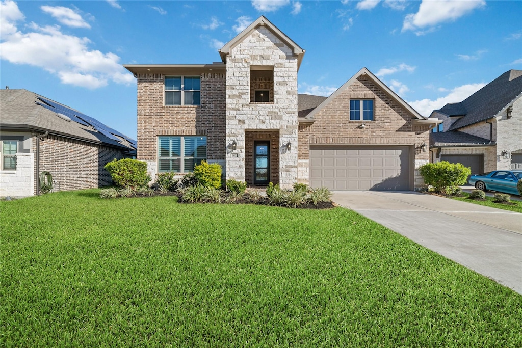 view of front of home with a garage and a front yard